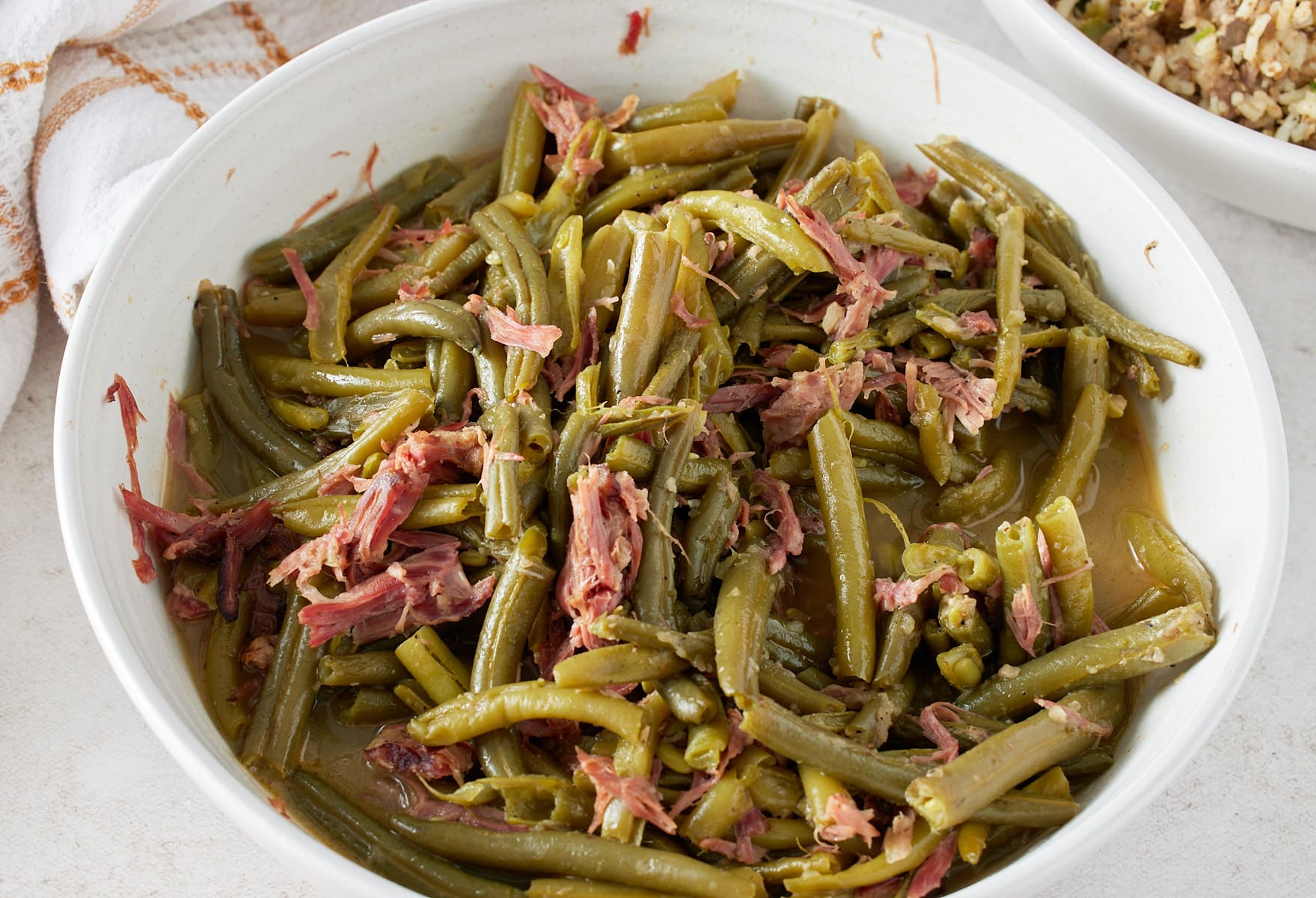 white bowl with green beans and smoked turkey