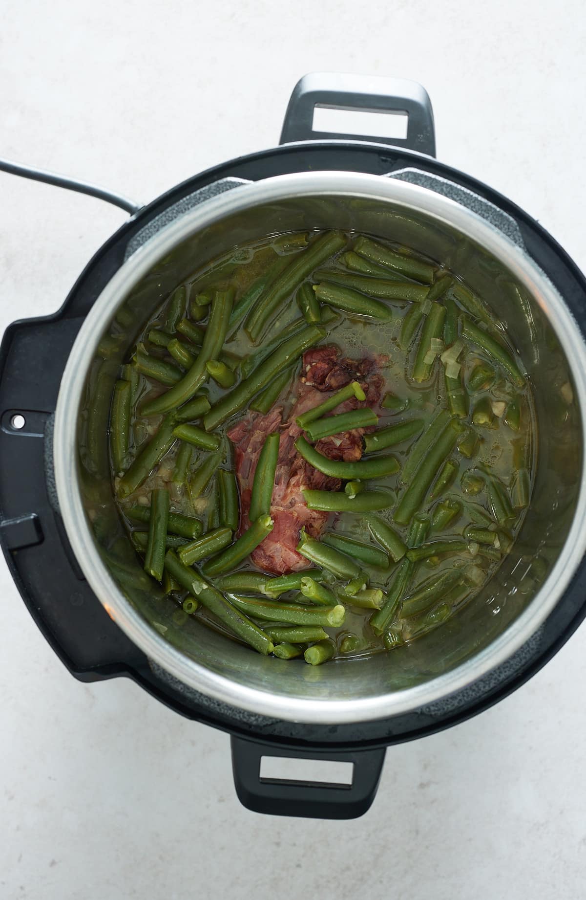 cooked green beans and smoked turkey in an instant pot