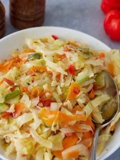 Jamaican steamed cabbage in a bowl with serving spoon