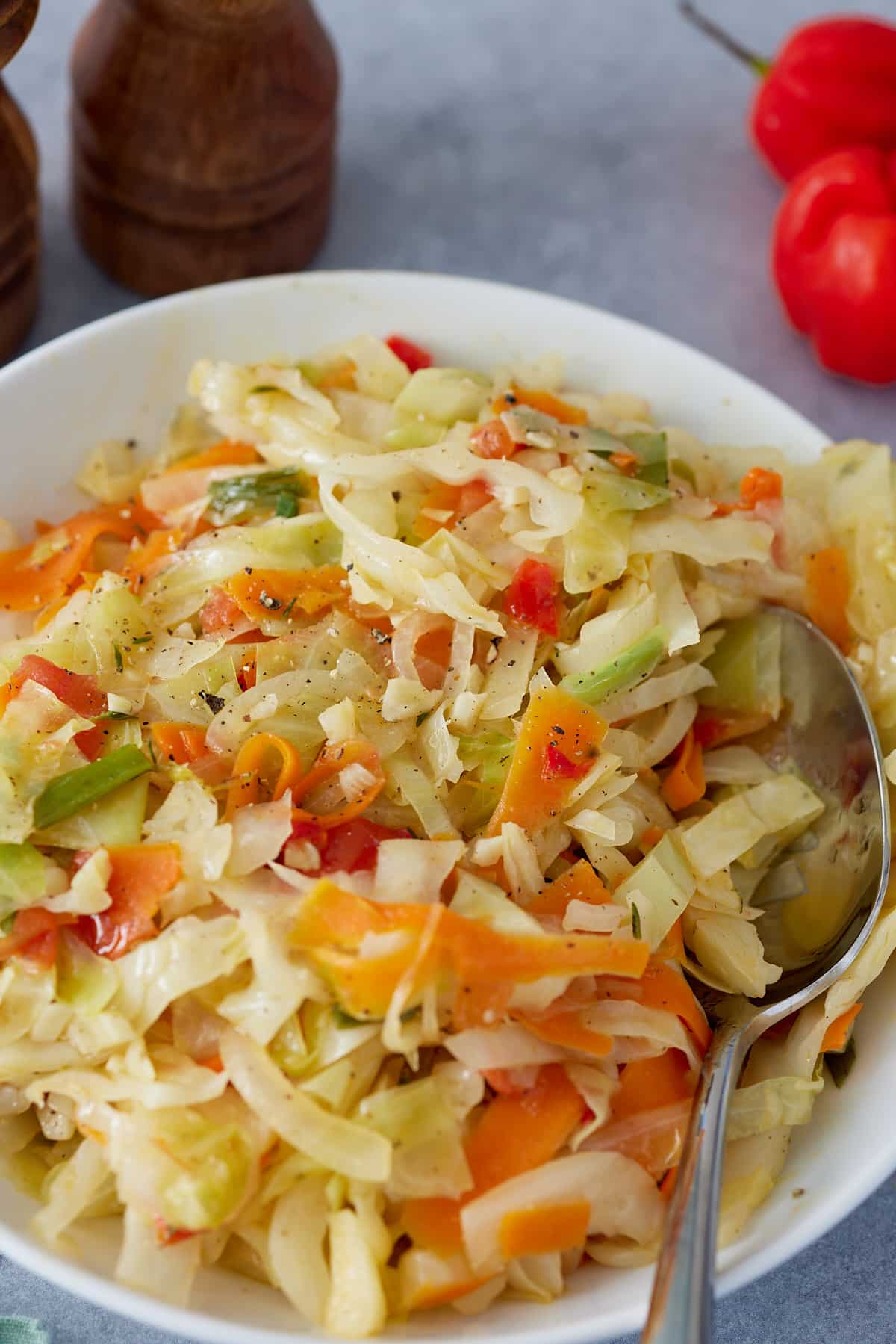 Jamaican steamed cabbage in a bowl with serving spoon