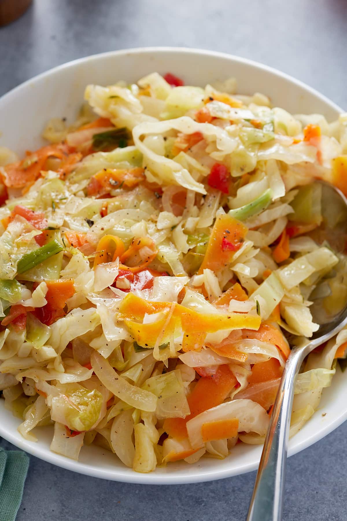 Jamaican steamed cabbage in a bowl with serving spoon