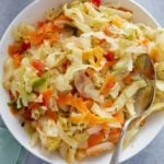 Jamaican steamed cabbage in a bowl with serving spoon