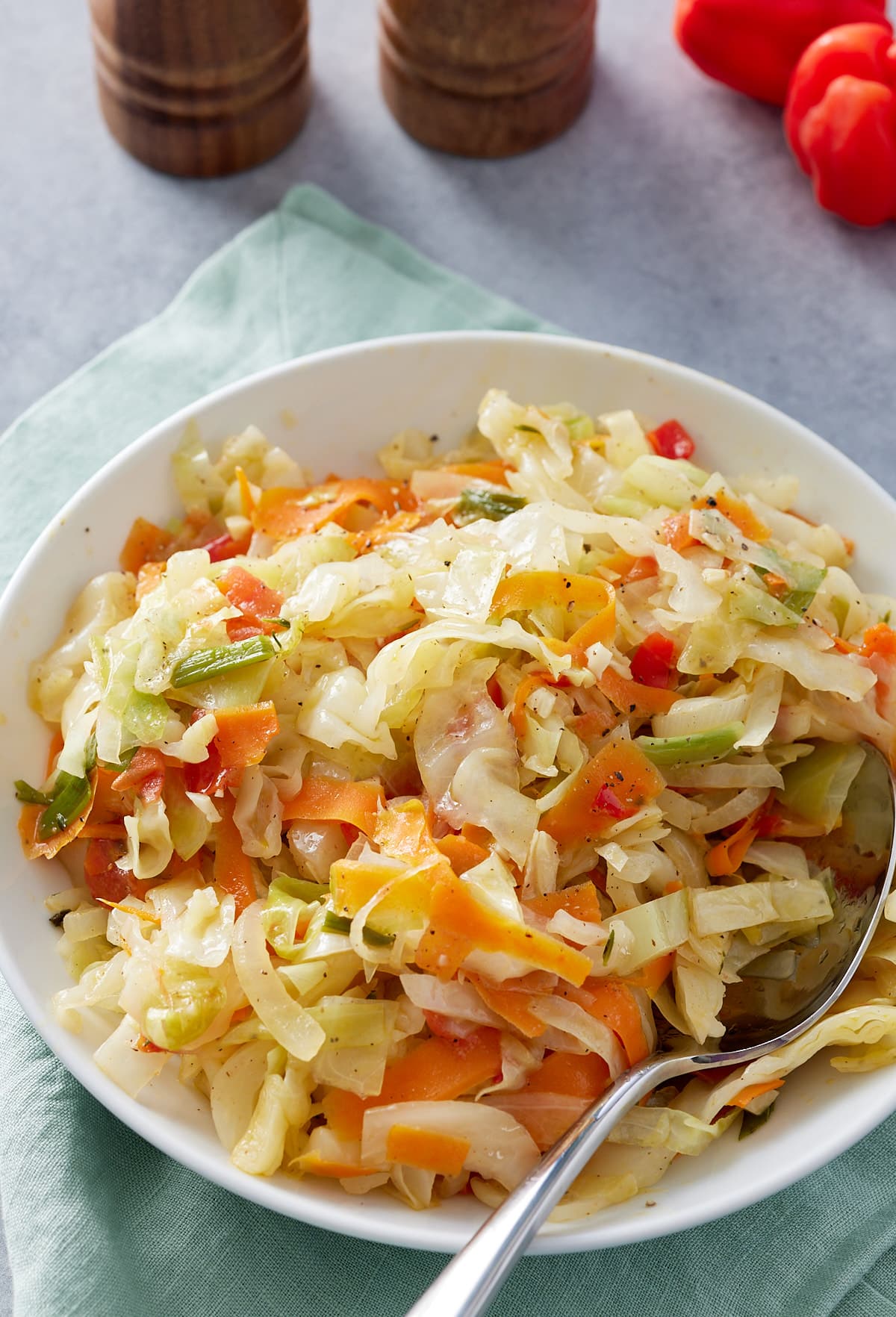 Jamaican steamed cabbage in a bowl with serving spoon