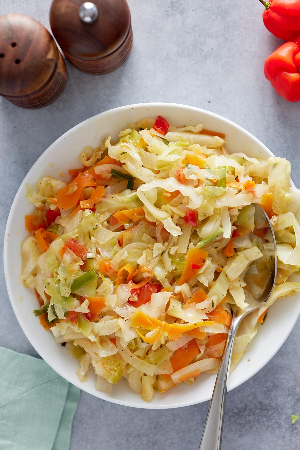 Jamaican steamed cabbage in a bowl with serving spoon