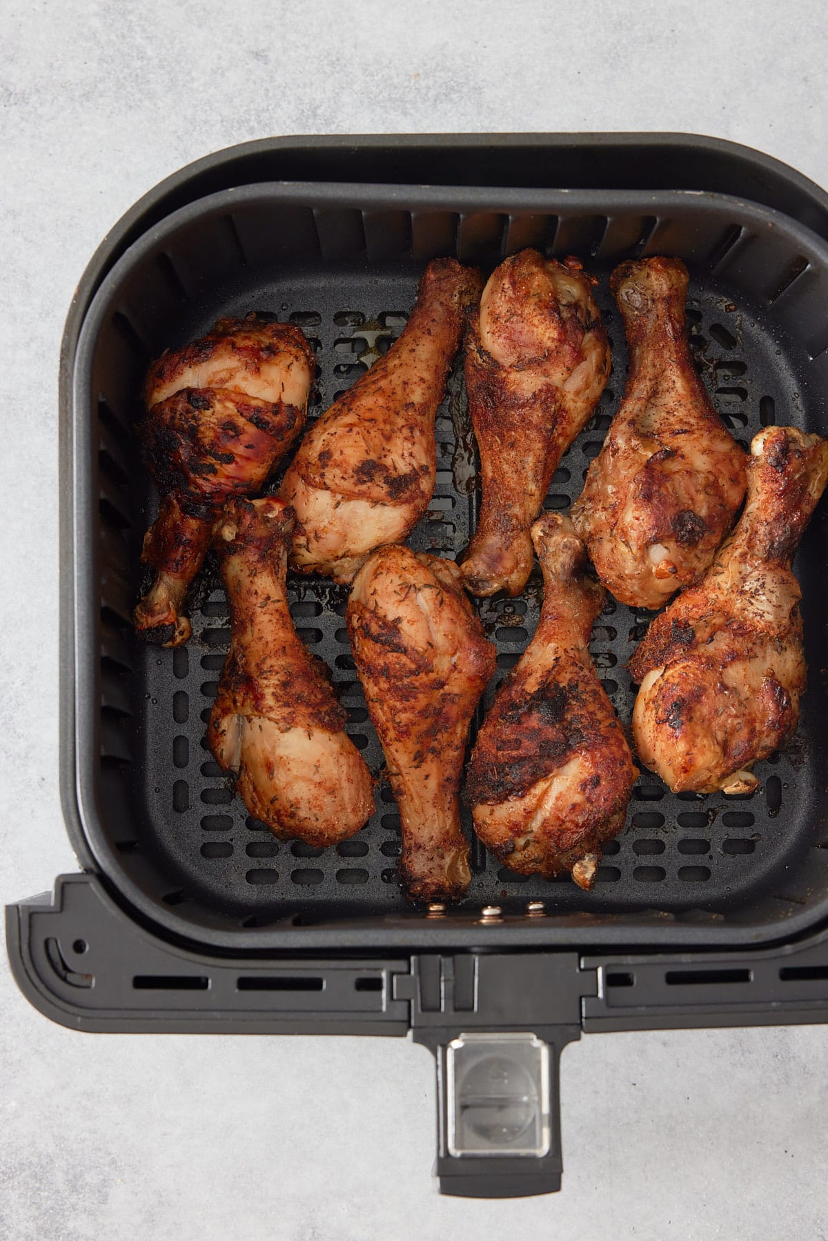 cooked chicken in an air fryer basket