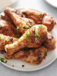 plate of garnished air fryer drumsticks