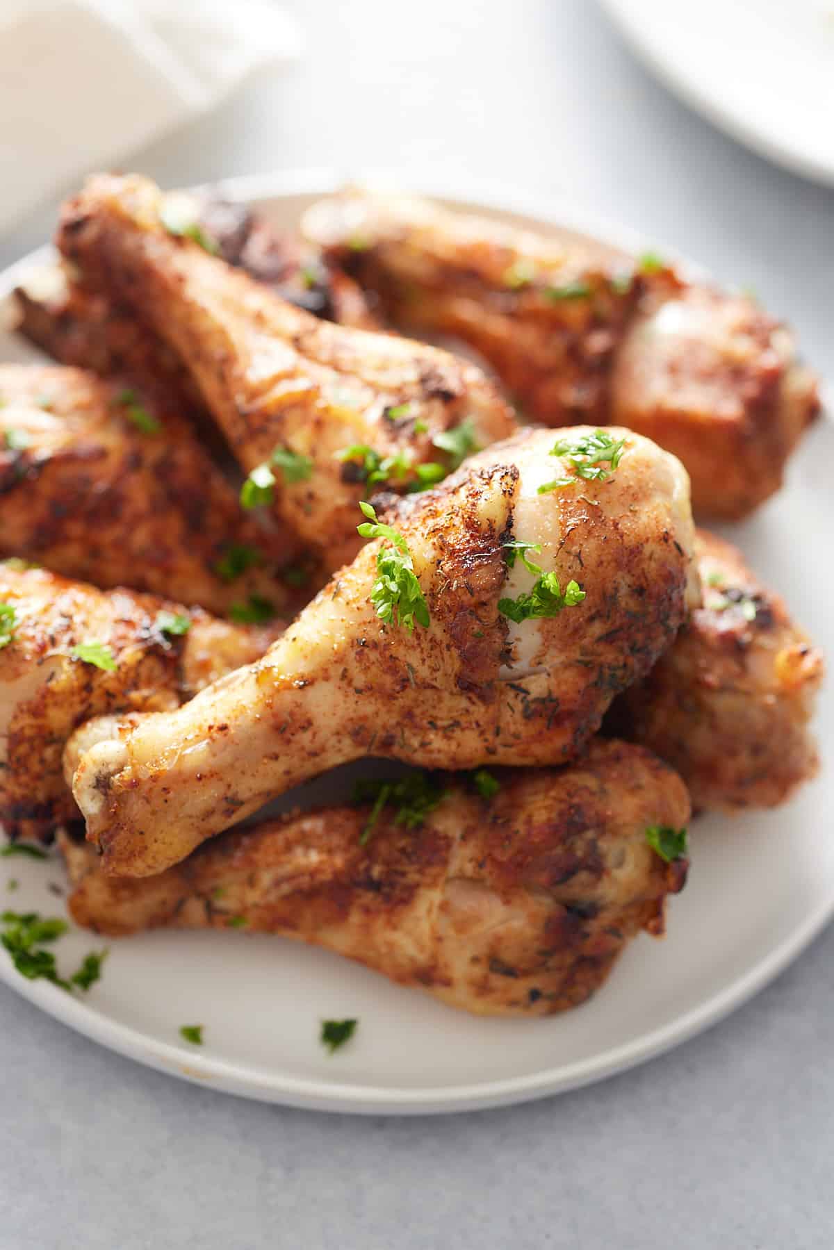 plate of garnished air fryer drumsticks