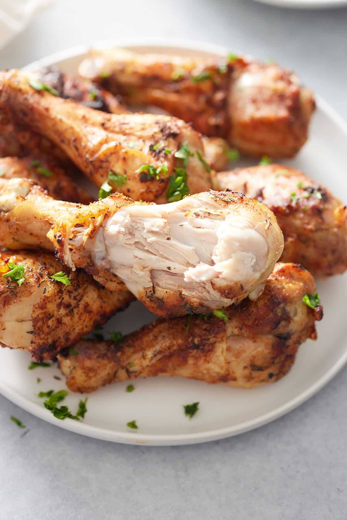 plate of chicken drumsticks with a bite taken out