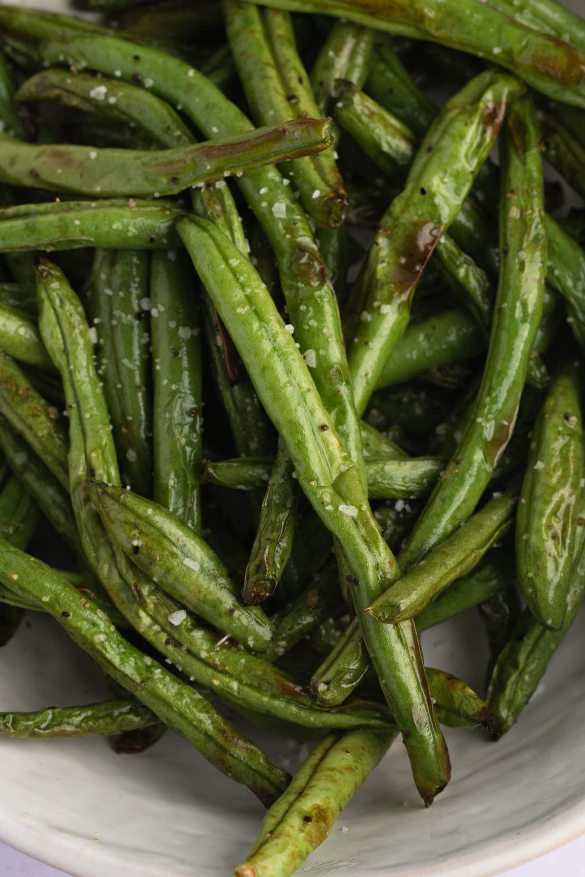 cooked green beans in a white serving bowl