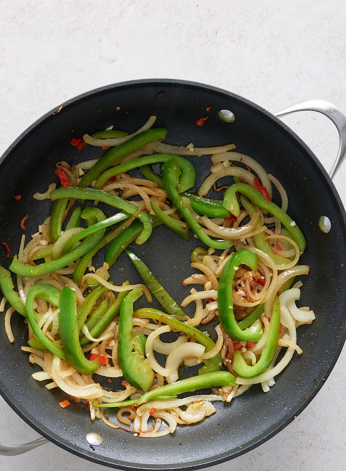 A black skillet with cooked vegetables