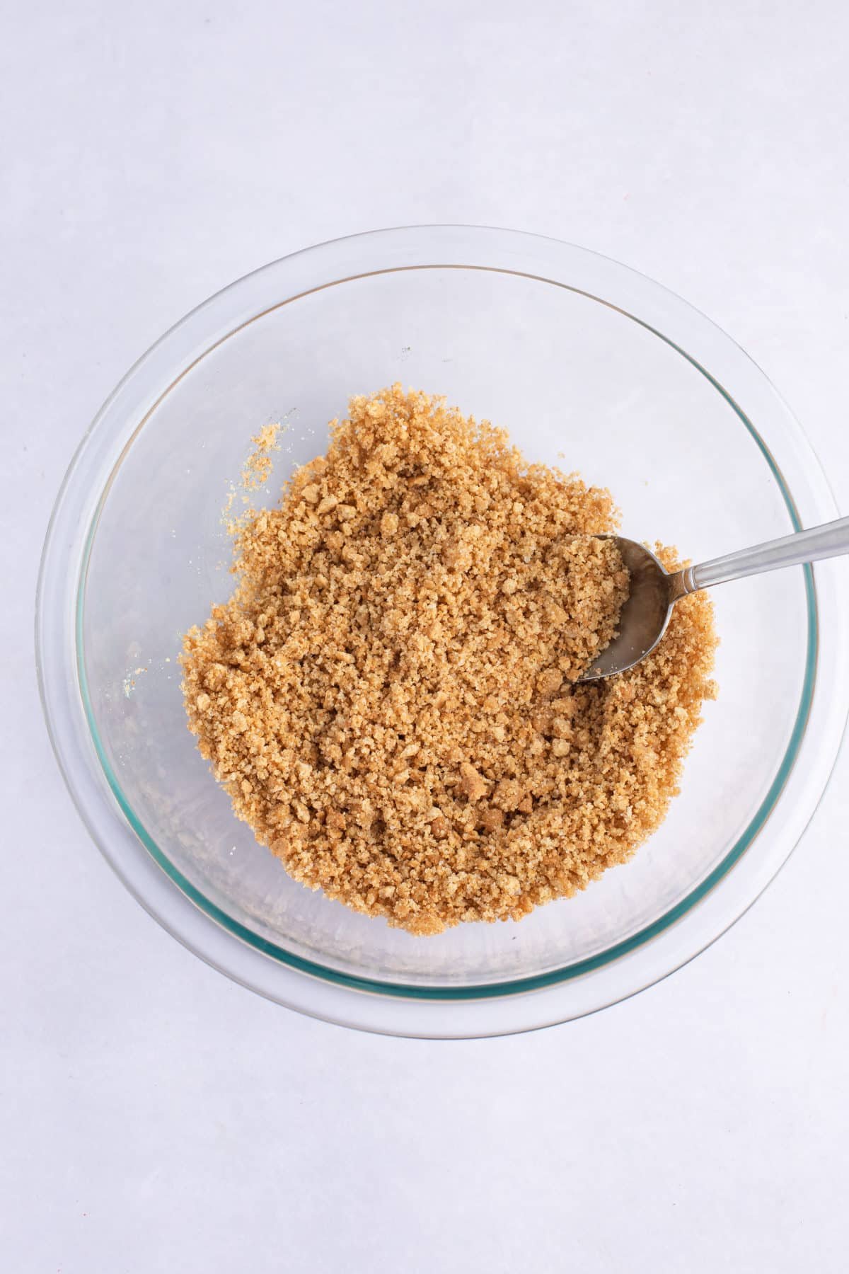 graham cracker crust mixture in a small glass bowl
