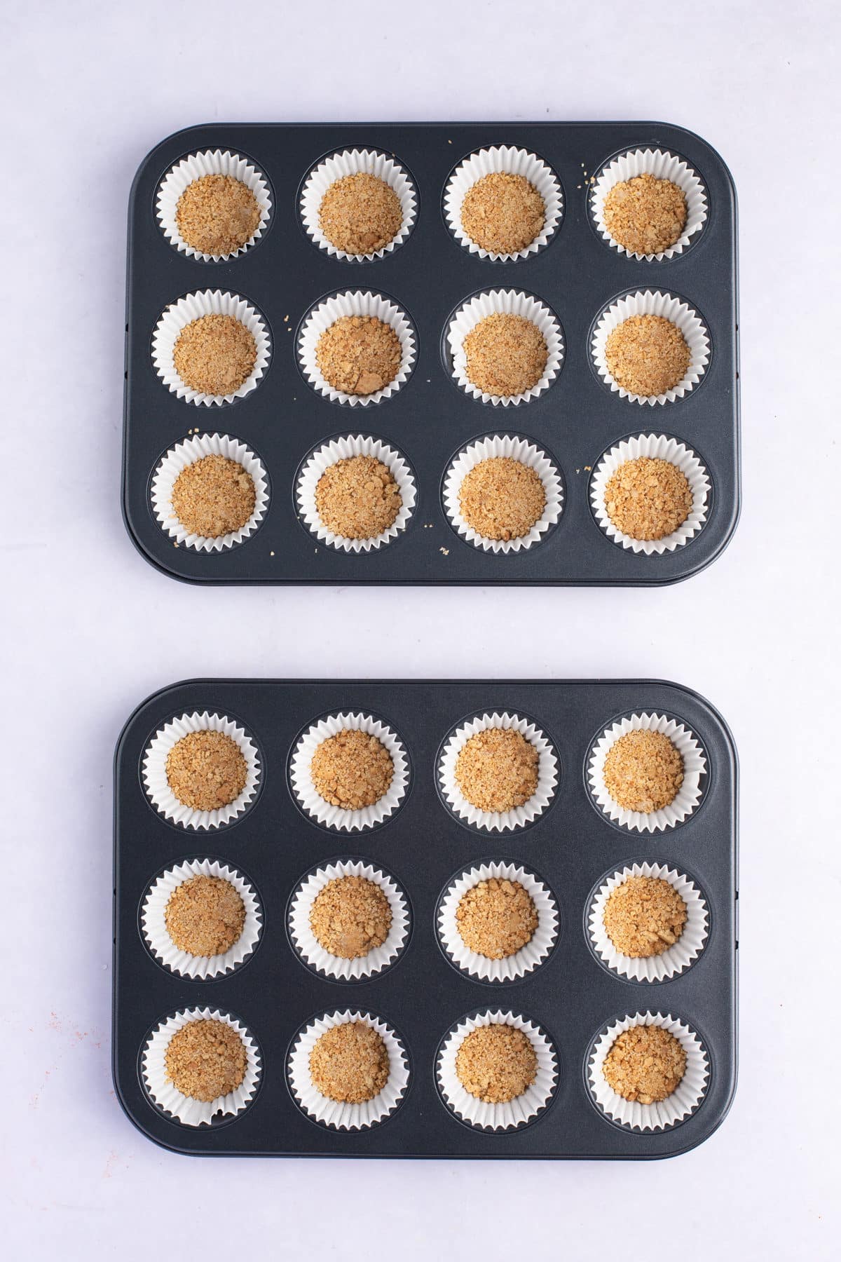 graham cracker crust mixture pressed into two mini muffin tins