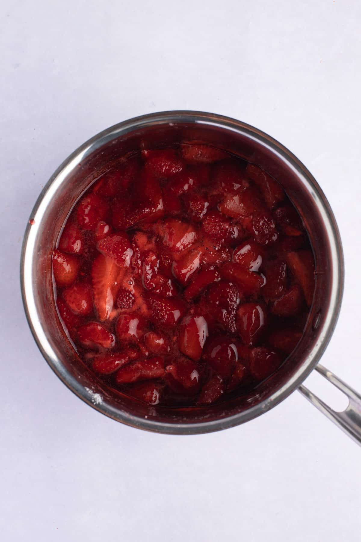 strawberry topping cooked in a saucepan