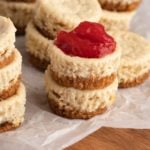 stacks of cheesecakes bites, one with a topping