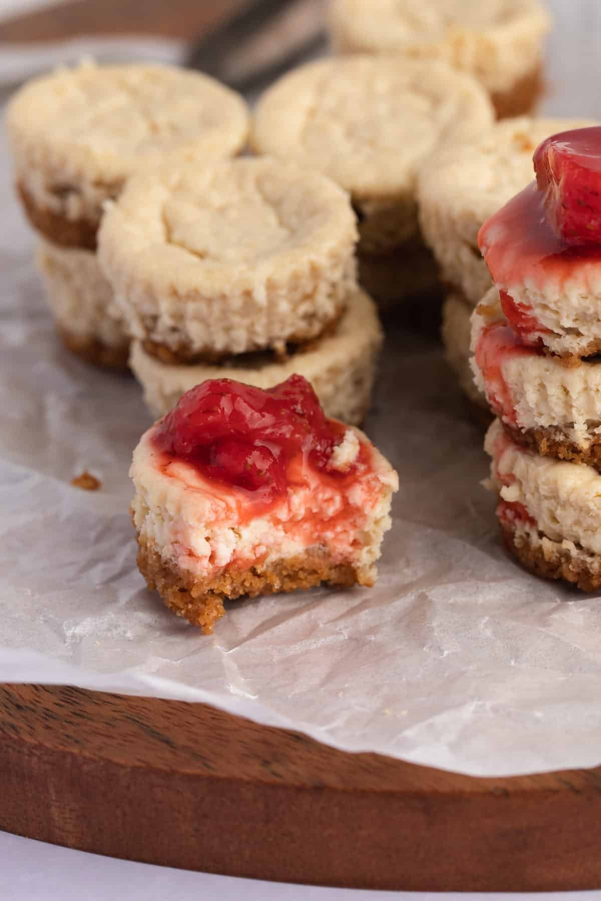 Stacks of cheesecake bites, one with a bite taken out