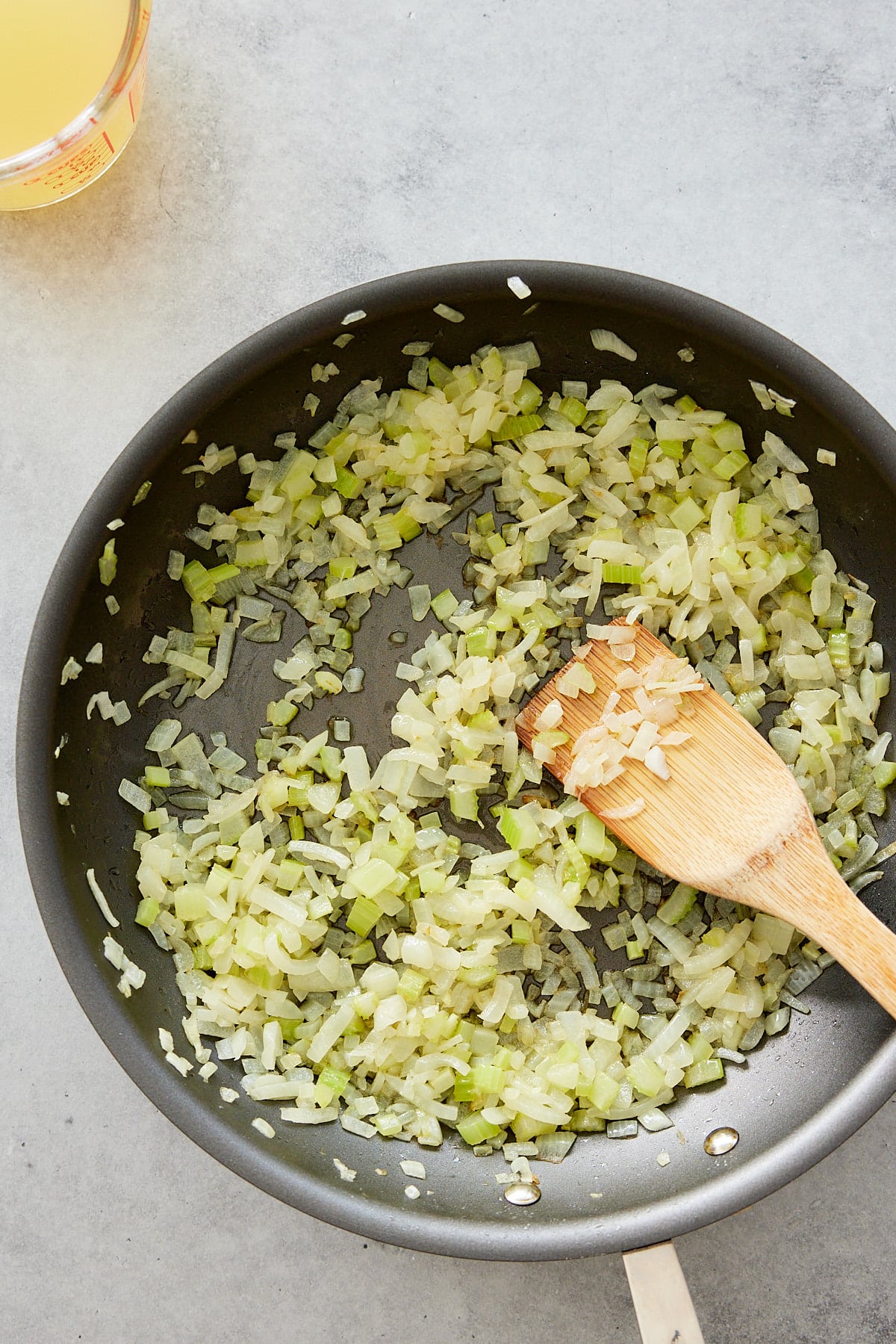 sauteeing vegetables in a pan on the stove