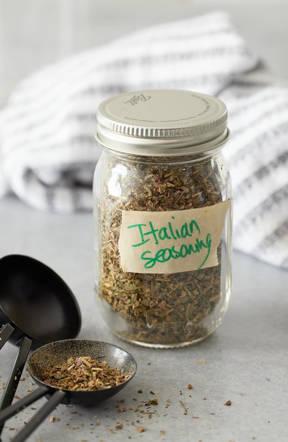 small jar filled with Italian seasoning labeled with tape