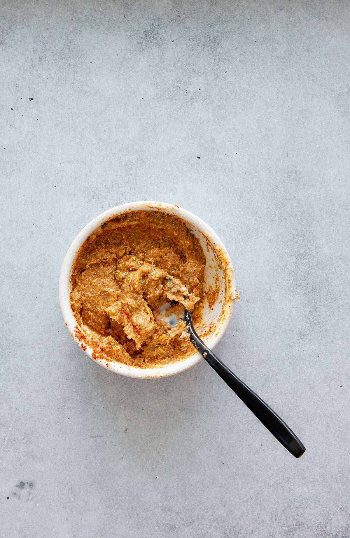 marinade for chicken mixed with a spoon in a bowl