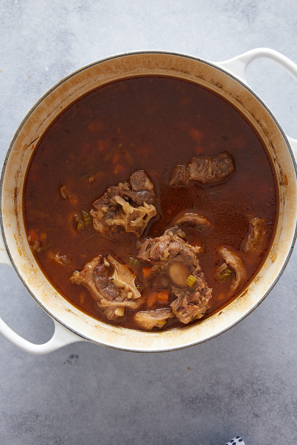 overhead view of a pot filled with cooked oxtail stew