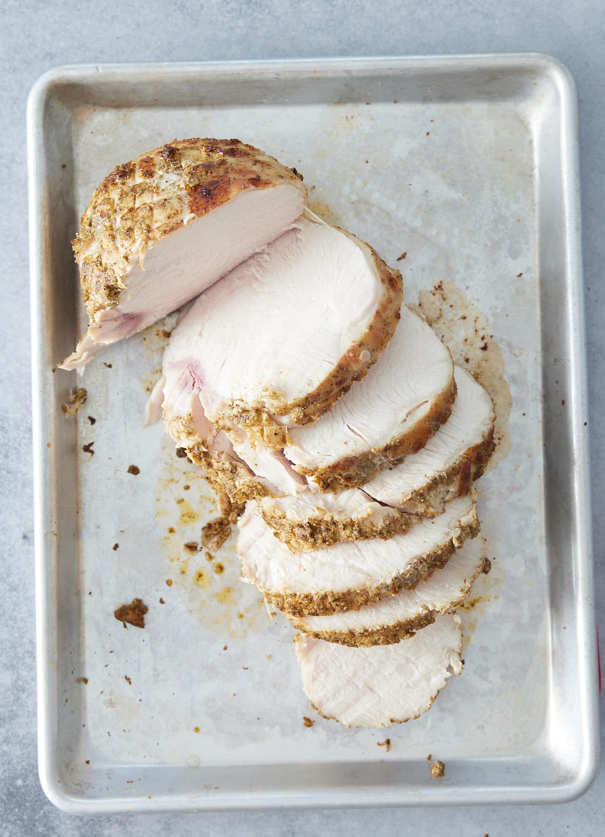 Sheet pan with roasted and sliced turkey breast