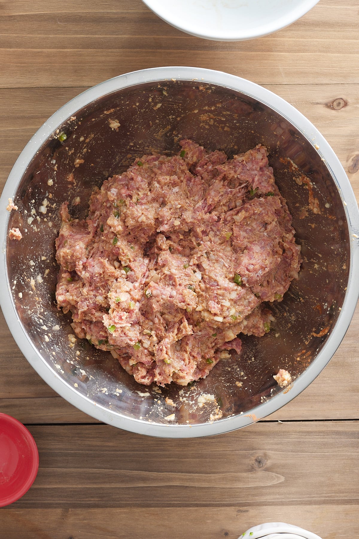 Large silver bowl with raw meatloaf mixture