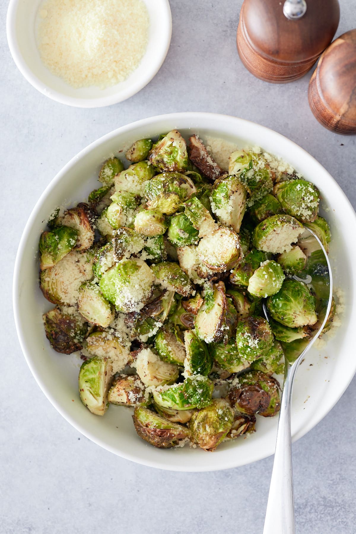 overhead shot of air fried brussels sprouts in a bowl with a spoon