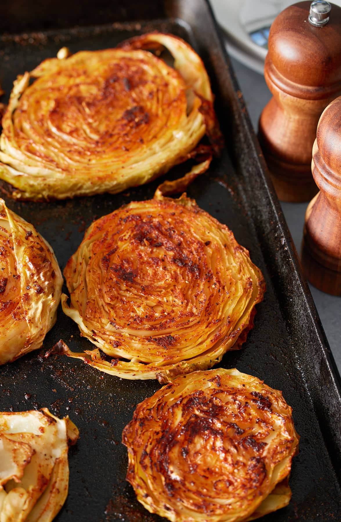 freshly baked cabbage steaks on a baking sheet