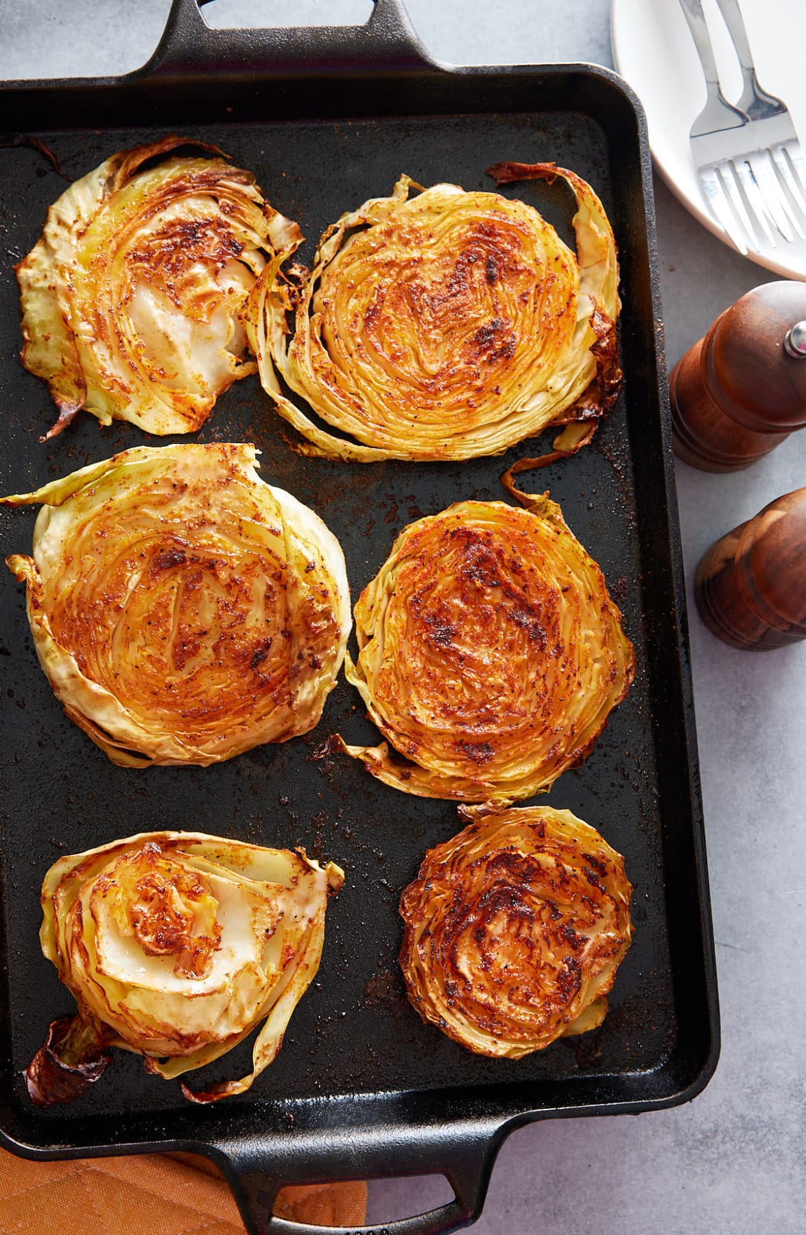 freshly baked cabbage steaks on a baking sheet