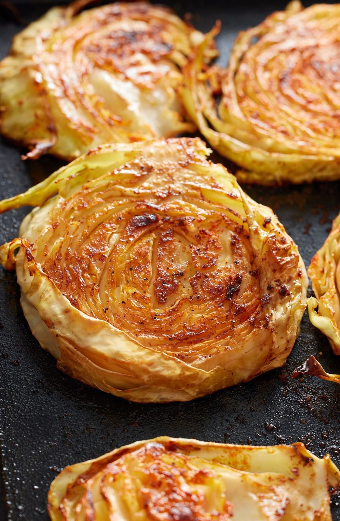 4 cabbage steaks on a dish