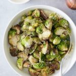 overhead shot of air fried brussels sprouts in a bowl with a spoon