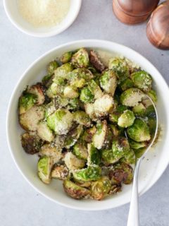 overhead shot of air fried brussels sprouts in a bowl with a spoon