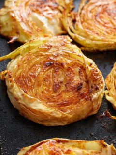 4 cabbage steaks on a dish