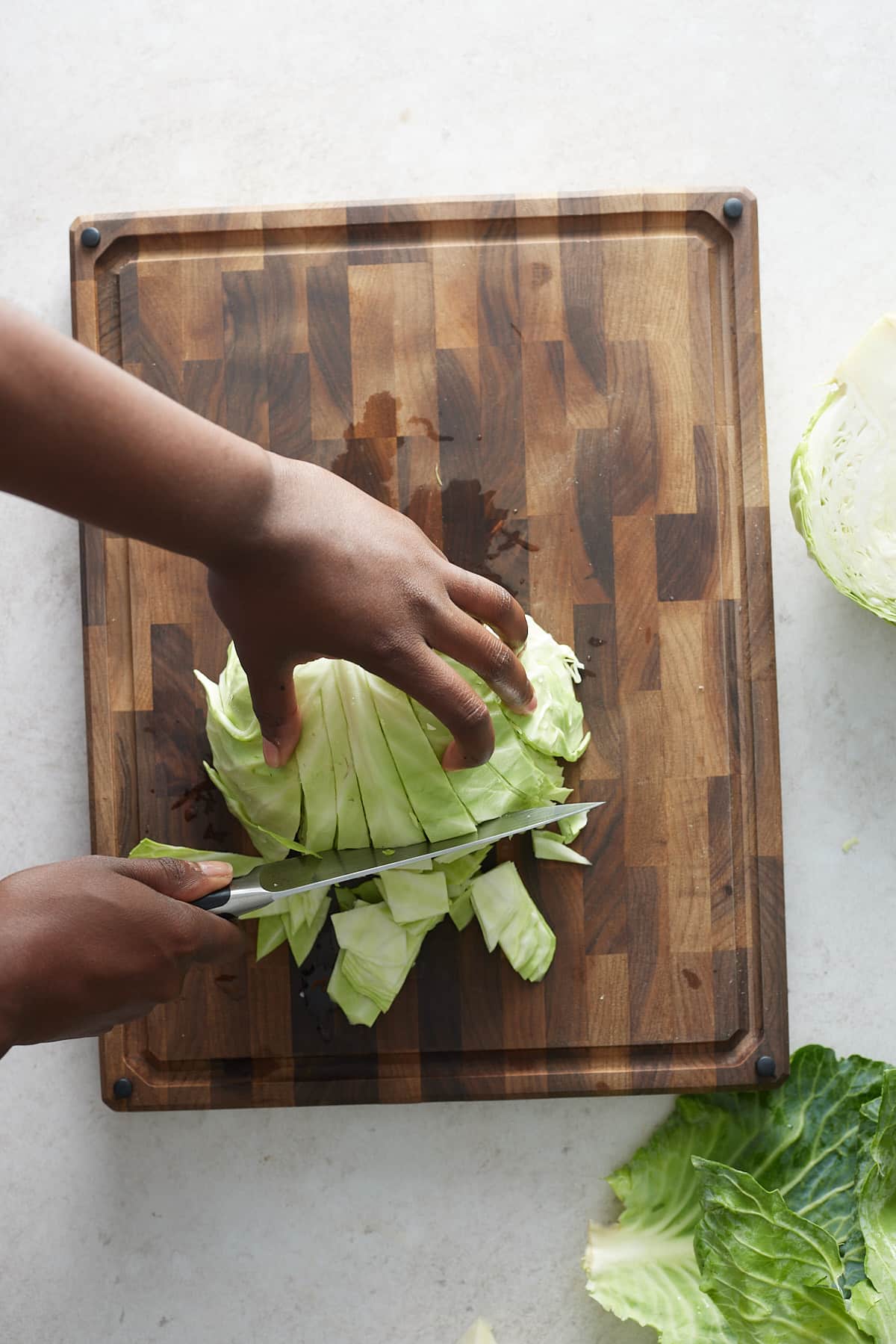 hand showing cabbage beng chopped