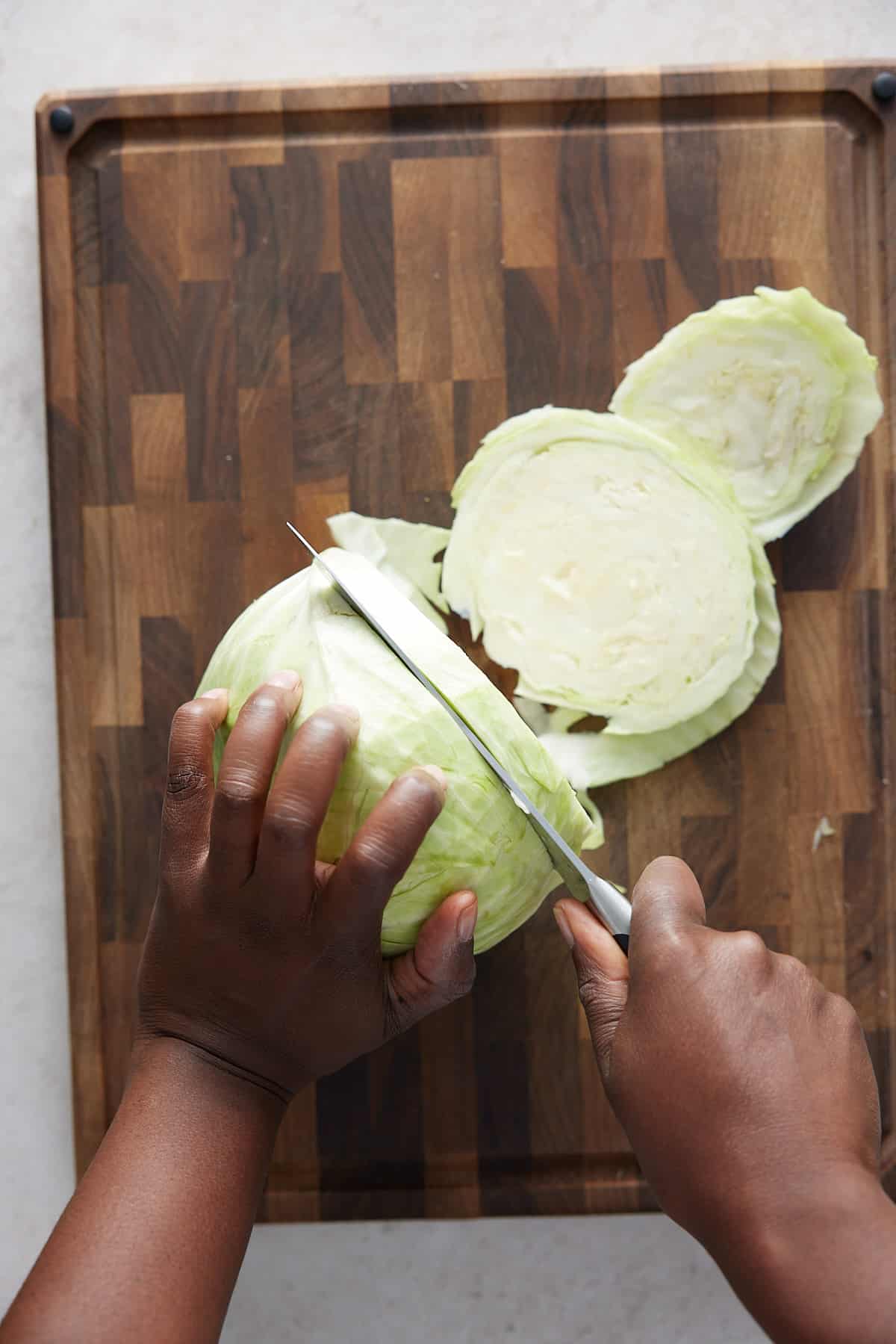 hand cutting cabbage steaks