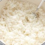 fresh baked rice being fluffed with a fork