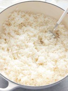fresh baked rice being fluffed with a fork
