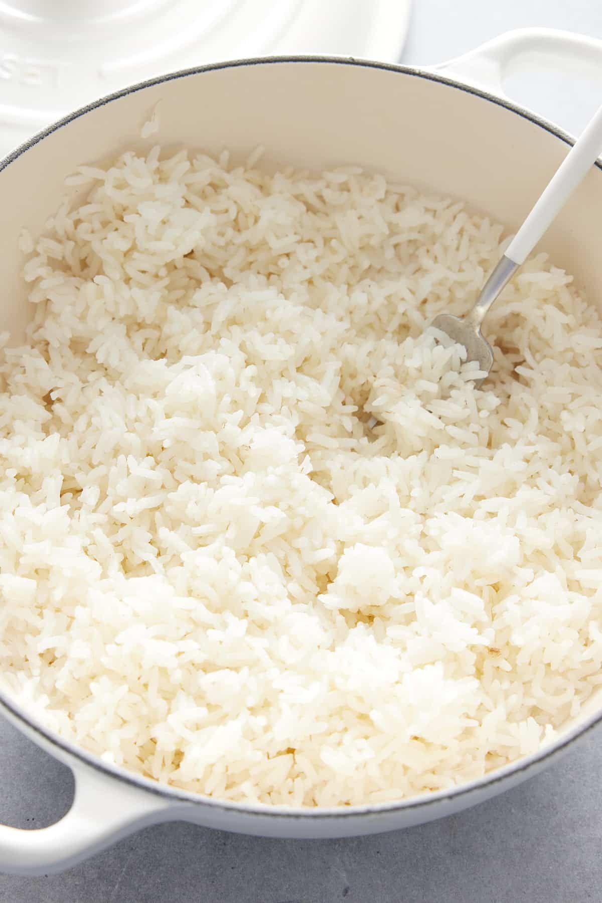 fresh baked rice being fluffed with a fork