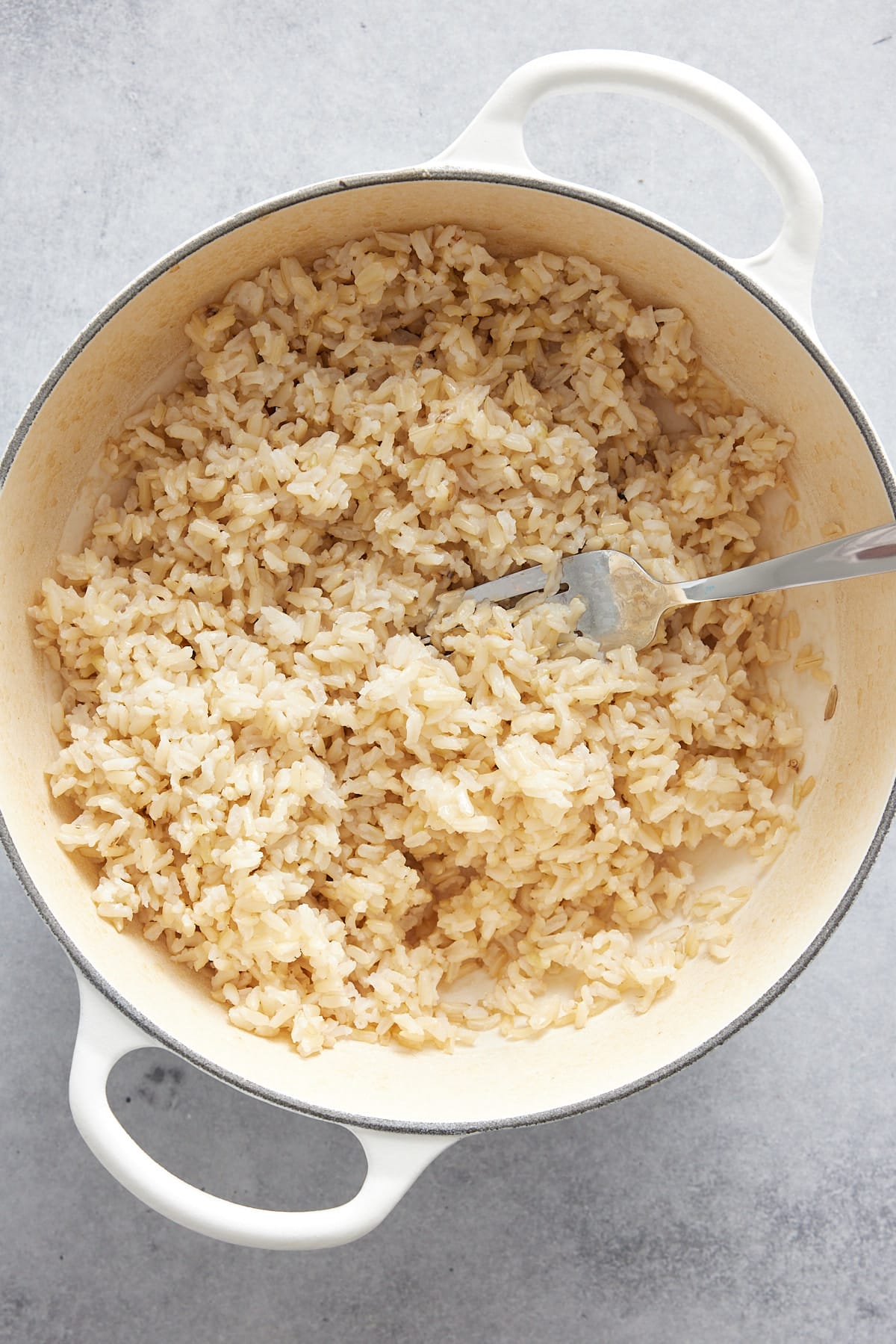 brown rice in dutch oven with fork