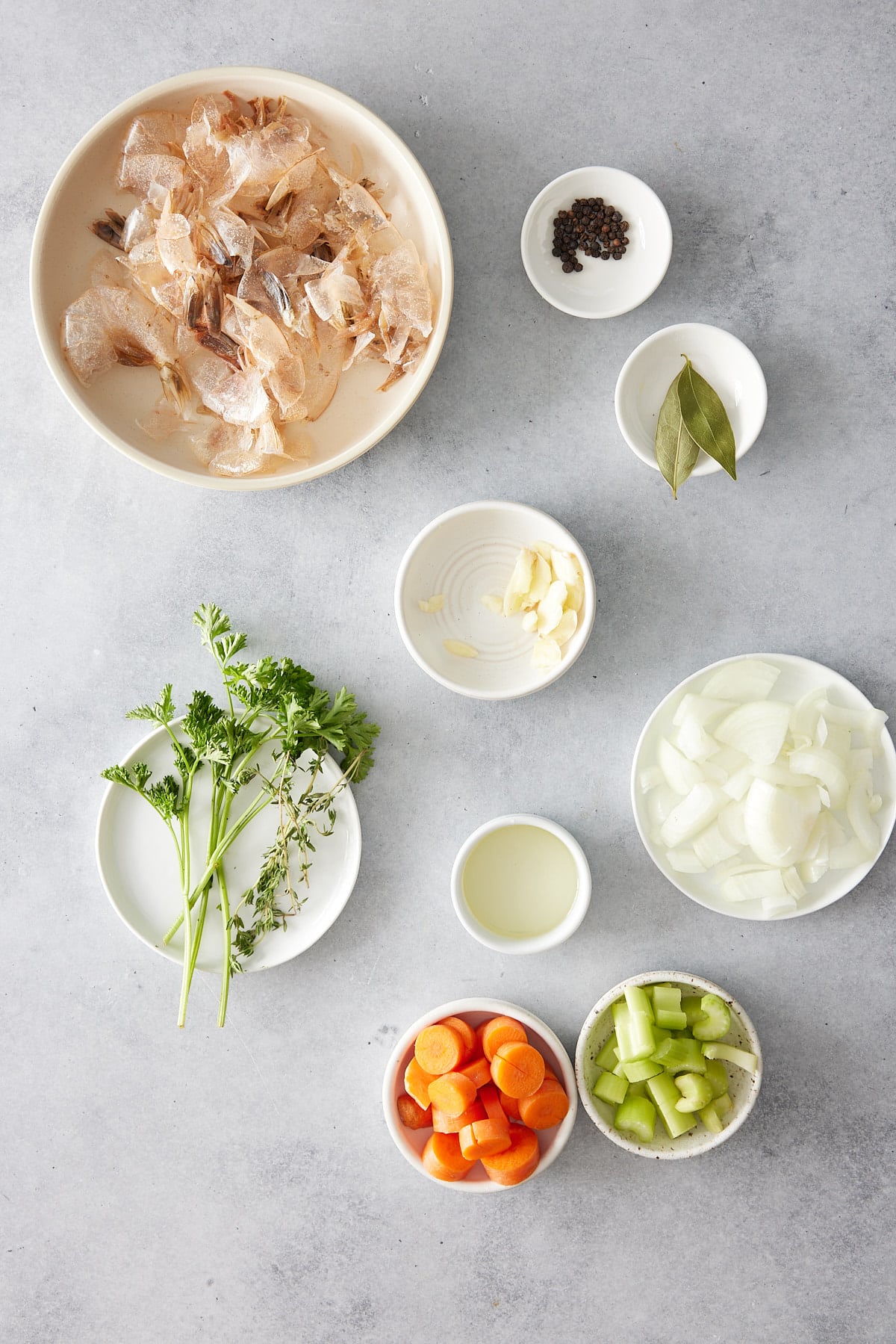 Shrimp stock recipe ingredients set into individual white bowls