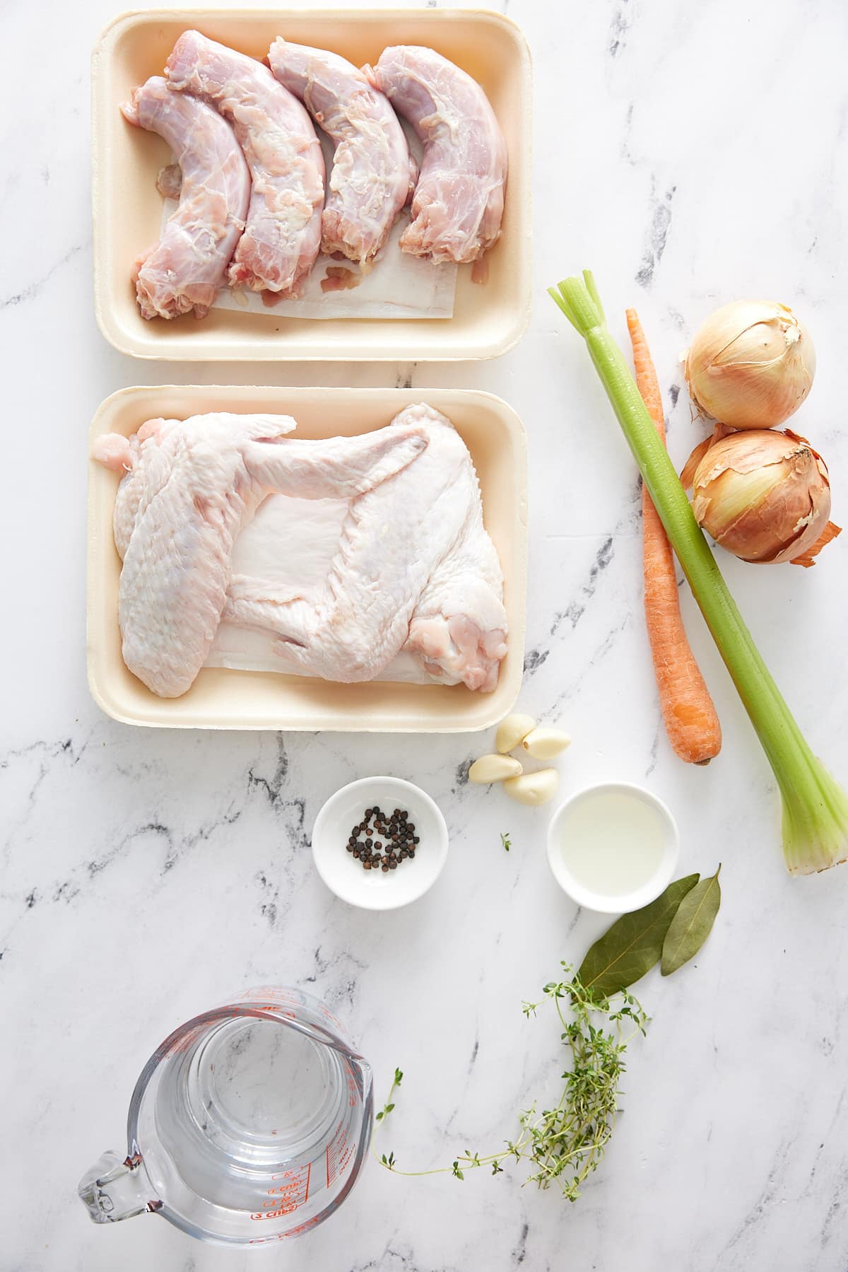 Turkey broth ingredients including turkey wings and neck, vegetables, herbs and seasoning