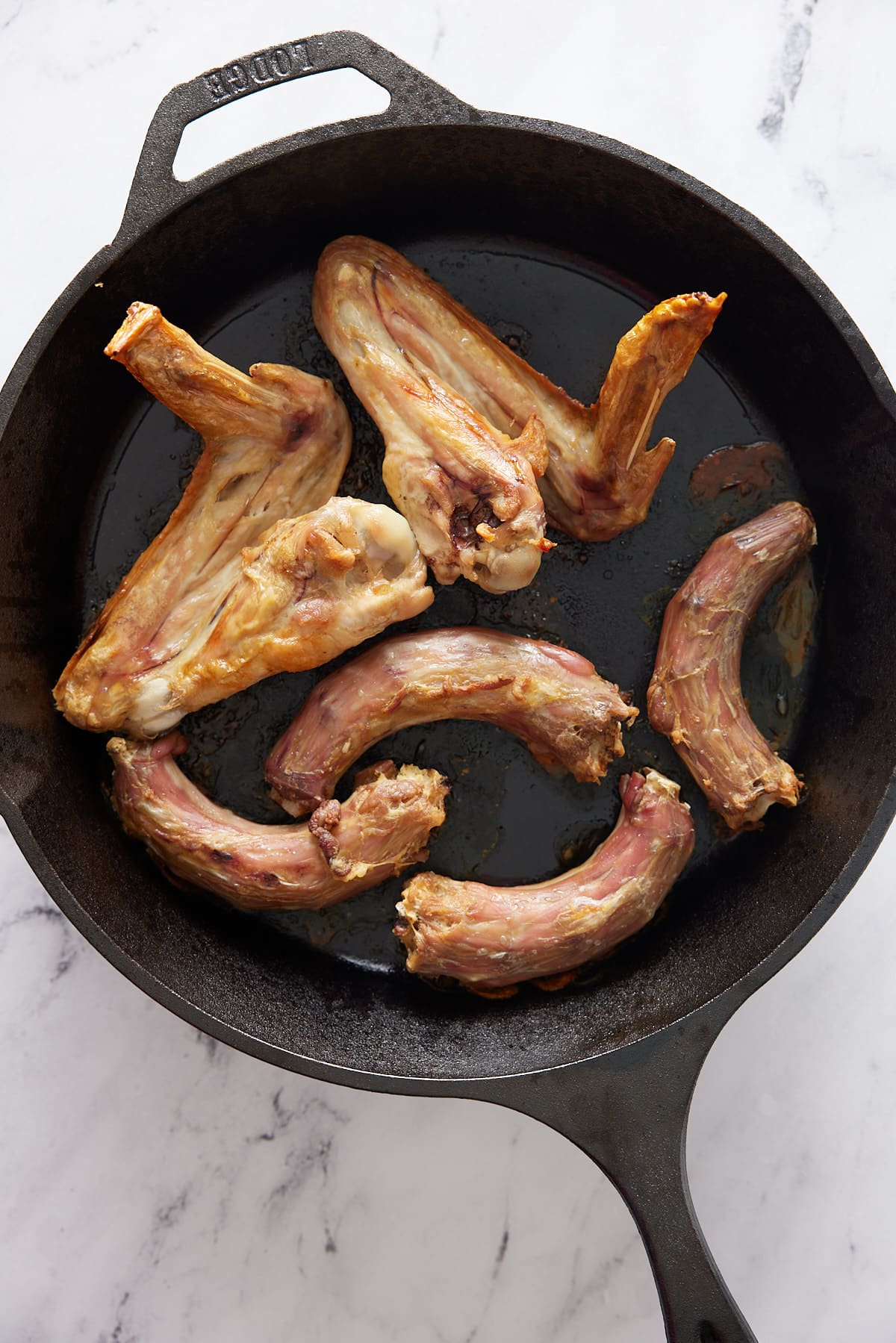 Cast iron skillet with roasted turkey wings and neck