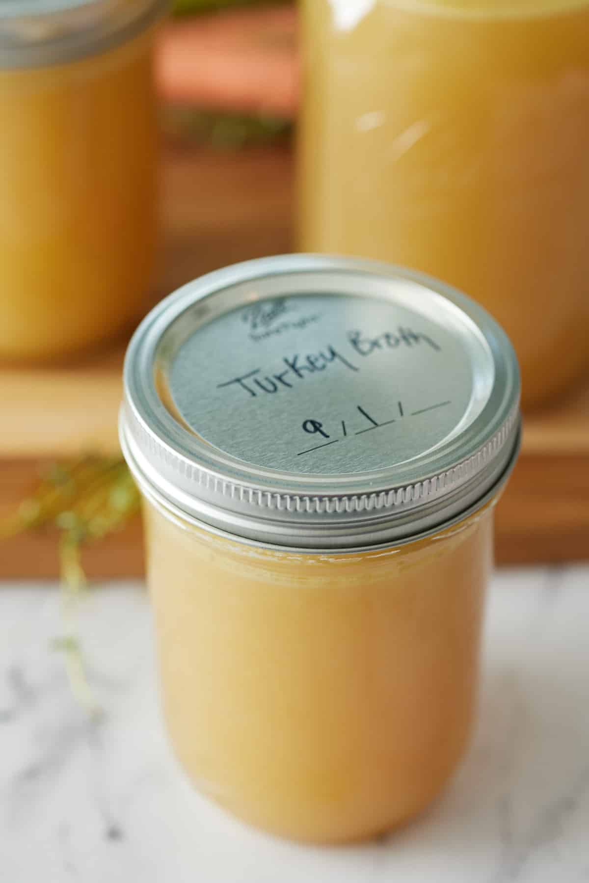 Close up of sealed and labeled jar of turkey broth