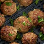 close up or turkey meatballs garnished in the air fryer basket