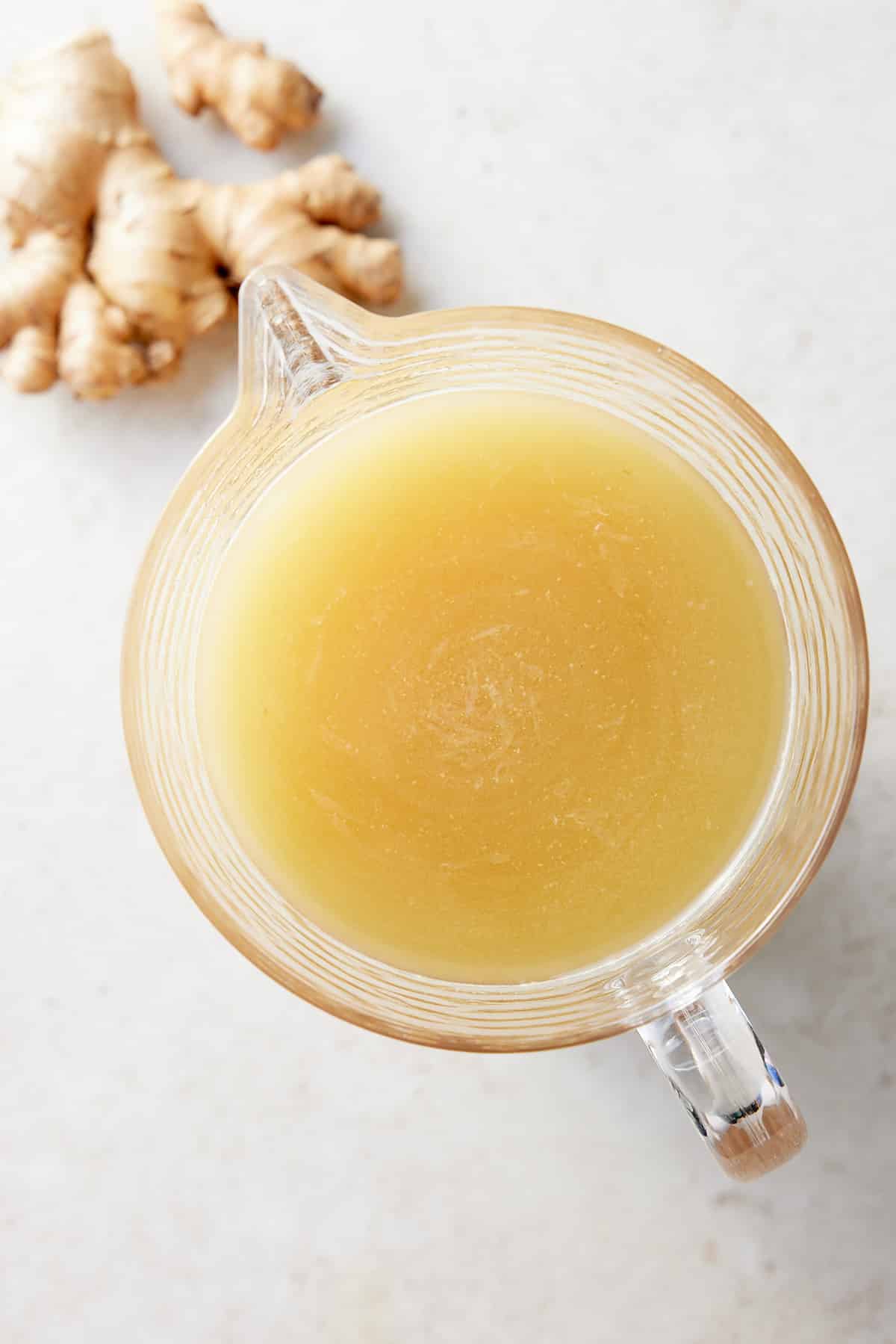 Glass pitcher filled with sieved Jamaican ginger beer