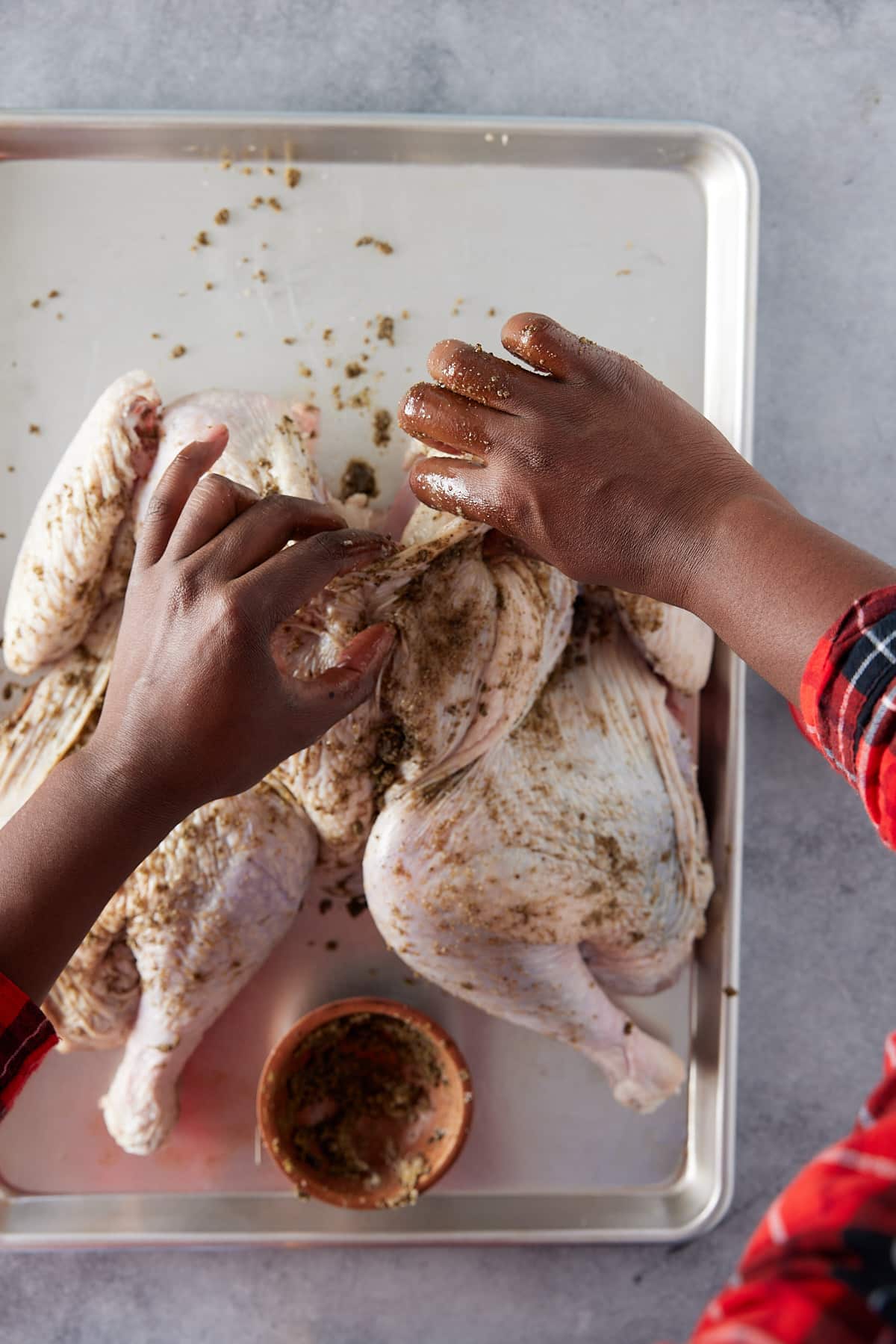 turkey being seasoned with season mixture