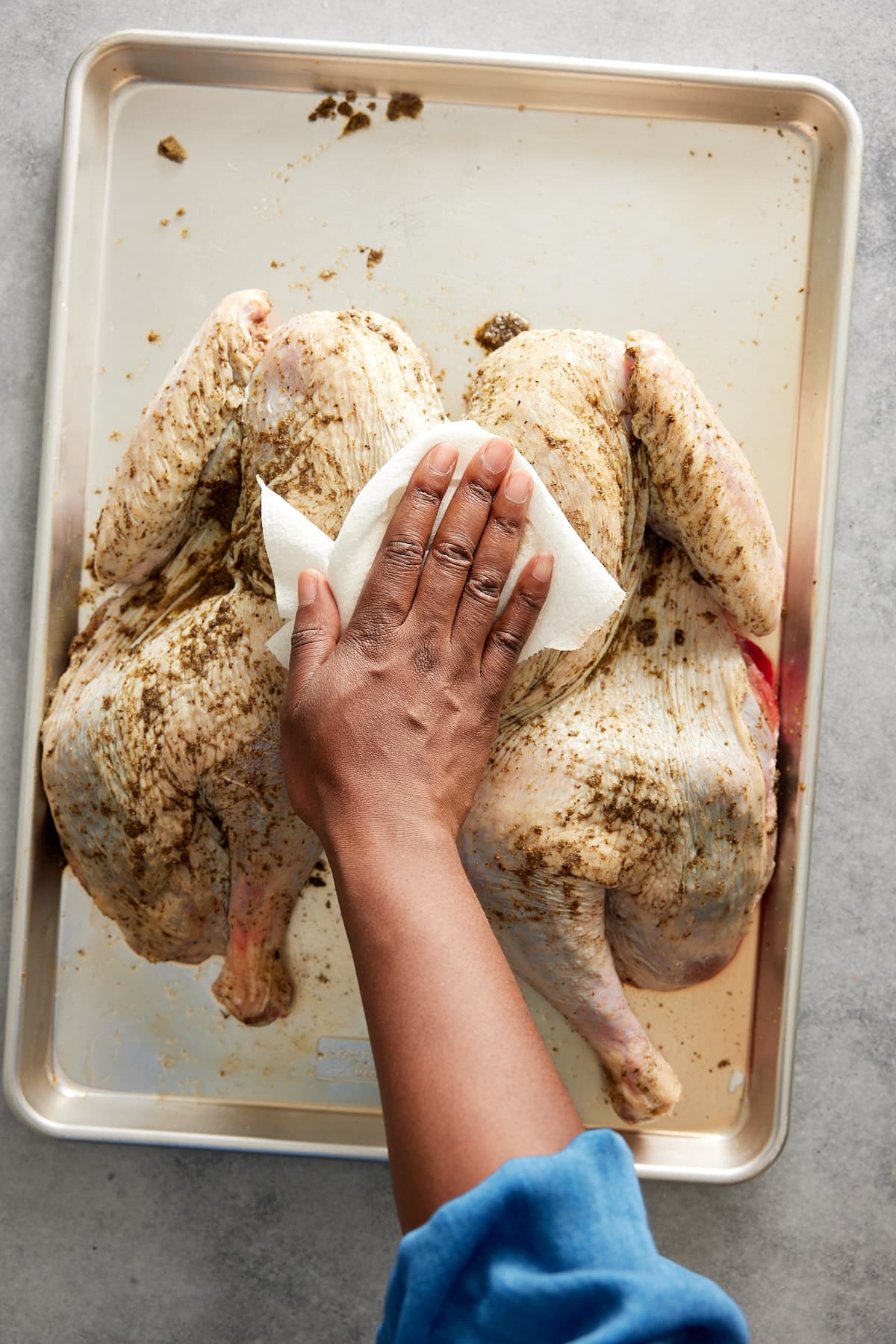 Patting the chilled turkey dry with a paper towel