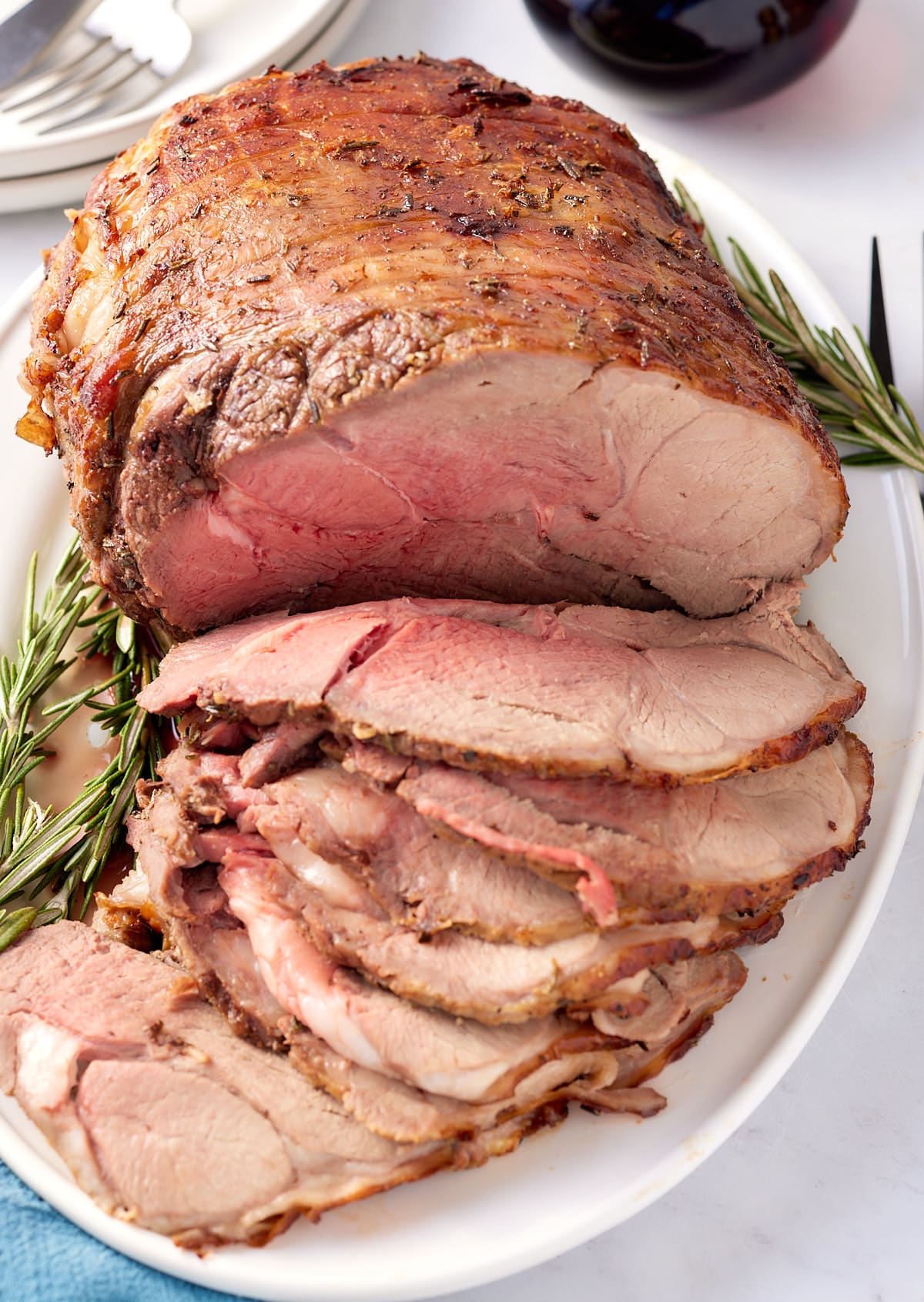 sliced leg of lamb on white plate