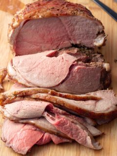 sliced leg of lamb on cutting board