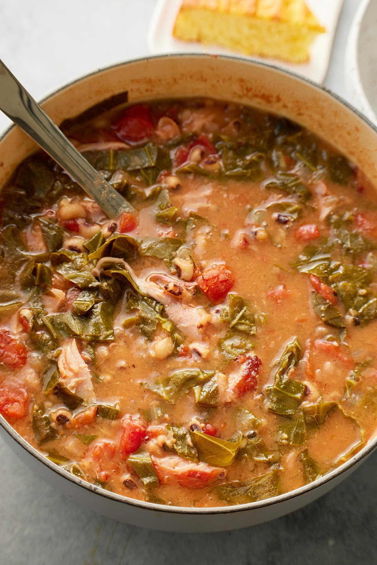 fresh pot of collard green soup with ladle