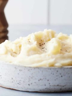 mashed potatoes in a bowl topped with salt and pepper